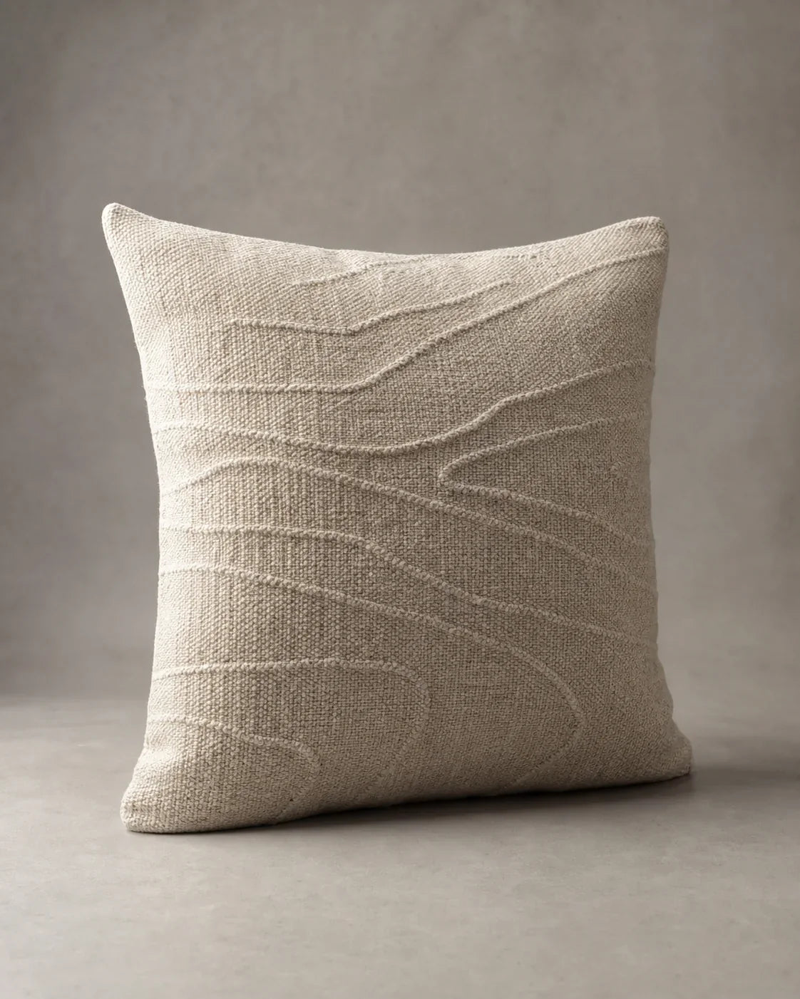 Shelter Handwoven Wool Cushion by ALPORA, a softly structured undyed-wool cushion with low-relief lines and a supportive natural fill concept